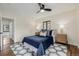 Sunlit bedroom featuring a fan, area rug, and stylish decor at 1190 Glencoe St, Denver, CO 80220