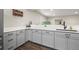 Close up of a finished basement bar area with grey cabinetry and white countertops at 2766 Keepsake Way, Castle Rock, CO 80109