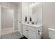 Bathroom with patterned tile, white vanity, and black hardware at 2766 Keepsake Way, Castle Rock, CO 80109