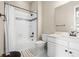 Clean bathroom featuring tub with shower, mosaic tile accent, and modern vanity at 2766 Keepsake Way, Castle Rock, CO 80109