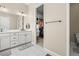 Neutral primary bathroom with double sinks, marble countertops, a walk-in closet, and a toilet room for added privacy at 2766 Keepsake Way, Castle Rock, CO 80109