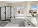 Bright bathroom featuring a separate glass shower, soaking tub, and modern vanity with double sinks at 2766 Keepsake Way, Castle Rock, CO 80109