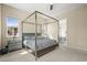 Serene bedroom featuring a canopy bed, plush bedding, and a glimpse into the en-suite bathroom at 2766 Keepsake Way, Castle Rock, CO 80109