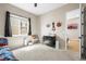 Cozy bedroom with soft carpet, large window, a dresser, and an attached bathroom, creating a comfortable retreat at 2766 Keepsake Way, Castle Rock, CO 80109