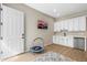Multipurpose bonus room with a small kitchenette, white cabinets, access to the backyard, and recessed lighting at 2766 Keepsake Way, Castle Rock, CO 80109