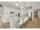 Bright kitchen featuring white cabinetry, stainless steel appliances, and a quartz island with seating at 2766 Keepsake Way, Castle Rock, CO 80109