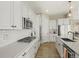 Modern kitchen with white cabinets, stainless steel appliances, and subway tile backsplash at 2766 Keepsake Way, Castle Rock, CO 80109