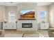 Comfortable living room featuring a fireplace with a decorative tile surround and built-in storage cabinets at 2766 Keepsake Way, Castle Rock, CO 80109