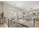 Open-concept living room with a fireplace, large windows, and access to an outdoor deck from the second floor at 2766 Keepsake Way, Castle Rock, CO 80109