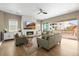 Cozy living room features a fireplace with a television, stylish furniture, and a sliding glass door to a deck at 2766 Keepsake Way, Castle Rock, CO 80109