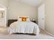 Bright bedroom featuring a white comforter, cheerful decorative pillows and carpeted floors at 2169 Eagle Ave # 2169, Superior, CO 80027