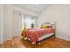 Bright bedroom with large window, hardwood floors, and iron bed frame at 2169 Eagle Ave # 2169, Superior, CO 80027