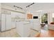Bright kitchen with island, white cabinetry, and seamless flow to the living area, ideal for entertaining at 2169 Eagle Ave # 2169, Superior, CO 80027