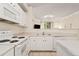 Well-equipped kitchen featuring white appliances, a breakfast bar, and ample counter space for cooking and prep at 2169 Eagle Ave # 2169, Superior, CO 80027