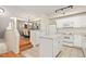 Bright kitchen with white cabinetry, island, and modern appliances, next to dining area at 2169 Eagle Ave # 2169, Superior, CO 80027