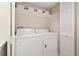 A convenient laundry room, complete with white appliances and storage at 2169 Eagle Ave # 2169, Superior, CO 80027