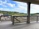 Covered back deck with railings and beautiful mountain views at 3967 Descent St, Castle Rock, CO 80108