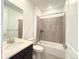 Bathroom featuring a vanity, toilet, bathtub, shower with gray tiling and modern fixtures at 3967 Descent St, Castle Rock, CO 80108
