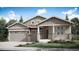 Inviting single-story home featuring a charming front porch, stone accents, and a two-car garage at 3967 Descent St, Castle Rock, CO 80108