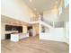 Bright, open-concept living room featuring beautiful hardwood floors, large windows, and a staircase at 3967 Descent St, Castle Rock, CO 80108