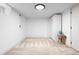 Neutral basement featuring plush carpeting, white walls, built-in closet, and accent furniture at 659 Albion St, Denver, CO 80220
