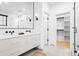 Elegant bathroom with double vanity, large mirror, and walk-in closet at 659 Albion St, Denver, CO 80220