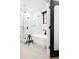 Bright bathroom featuring a soaking tub, glass-enclosed shower and stylish black accents at 659 Albion St, Denver, CO 80220