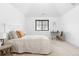 Cozy bedroom with neutral carpet, white iron bed and modern decor at 659 Albion St, Denver, CO 80220