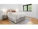 This bedroom features hardwood floors, a plush bed, and a large window at 659 Albion St, Denver, CO 80220