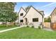 A beautiful house showcases its unique architectural design, lush lawn, and a charming outdoor seating area at 659 Albion St, Denver, CO 80220