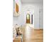 Bright foyer with hardwood floors, a decorative tapestry, and an arched doorway leading further inside at 659 Albion St, Denver, CO 80220