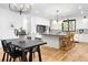 This open kitchen features hardwood floors, a black countertop island with seating, and stainless steel appliances at 659 Albion St, Denver, CO 80220