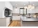 This spacious kitchen features white cabinets, stainless steel appliances, hardwood floors, and a black countertop island at 659 Albion St, Denver, CO 80220