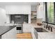 This is a spacious kitchen that features marble countertops and backsplash, stainless steel appliances, and hardwood floors at 659 Albion St, Denver, CO 80220