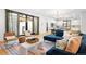 Open-concept living space featuring a modern chandelier, comfortable seating, and access to the outdoors at 659 Albion St, Denver, CO 80220