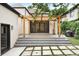 Staged patio with a wooden pergola, string lights, large glass doors, and attractive backyard landscaping at 659 Albion St, Denver, CO 80220