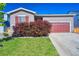 A well maintained front yard with green grass and an attractive burgundy bush accents this charming home at 6221 N Easton Ave, Frederick, CO 80504