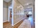 Bright hallway features wood floors and decorative wall paneling with sconce lighting at 6221 N Easton Ave, Frederick, CO 80504