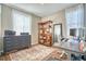 An organized home office features natural light and wood laminate flooring at 6221 N Easton Ave, Frederick, CO 80504