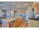 This modern kitchen boasts granite countertops, stainless appliances, and an island with seating at 6221 N Easton Ave, Frederick, CO 80504