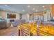 Open-concept living space featuring wood laminate flooring and a connected kitchen and seating area at 6221 N Easton Ave, Frederick, CO 80504