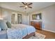 Cozy main bedroom showcasing a ceiling fan, hardwood floors, dresser, and serene natural lighting at 6221 N Easton Ave, Frederick, CO 80504