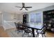 A dining room features a wooden table, hardwood flooring, and a large window to add natural light at 15541 E Cornell Ave, Aurora, CO 80013