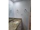 Bathroom featuring a granite countertop with a white cabinet and a large mirror at 1304 S Parker Rd # 13, Denver, CO 80231