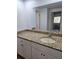 Bathroom featuring a granite countertop with a white cabinet and a large mirror at 1304 S Parker Rd # 13, Denver, CO 80231