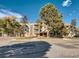 Exterior view of condo building with balconies and well-maintained landscaping at 1304 S Parker Rd # 13, Denver, CO 80231