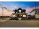 Inviting two-story home with covered front porch and manicured landscaping at sunset at 5965 Hanover St, Denver, CO 80238