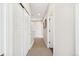 This hallway has neutral colored walls and carpet. It's also lit by recessed ceiling lights at 5965 Hanover St, Denver, CO 80238