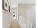 Bright hallway with carpet flooring and white trim leading to the bedrooms at 5965 Hanover St, Denver, CO 80238