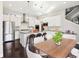 Bright kitchen with stainless steel appliances, an island with bar seating, and elegant white cabinetry at 5965 Hanover St, Denver, CO 80238